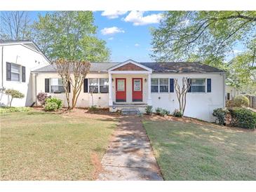 Charming duplex-style home with a well-maintained lawn and mature trees at 1509 Stone Gate Ln, Atlanta, GA 30317
