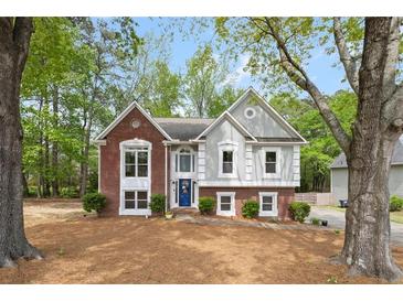 Charming two-story home features a well-manicured front yard and beautiful brick and siding accents at 3450 N Cook Rd, Powder Springs, GA 30127