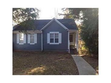 Charming single-story home with blue siding and white trimmed windows in a well-maintained yard at , Marietta, GA 30008