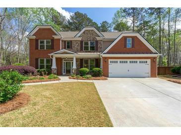 Charming brick and stone two-story home with a well-manicured lawn, perfect for families at 2251 Everleigh Ln, Marietta, GA 30064
