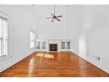 Bright living room with hardwood floors, fireplace, built-in cabinets, and soaring ceilings at 2116 Gorman Se Grv, Atlanta, GA 30316