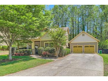 Charming home featuring a well-maintained lawn, complemented by an attached two-car garage and lush trees at 1714 Parkhill Dr, Decatur, GA 30032