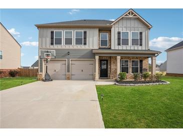 Charming two-story home with a two-car garage and well-manicured lawn at 89 Cowpen Ct, Covington, GA 30014
