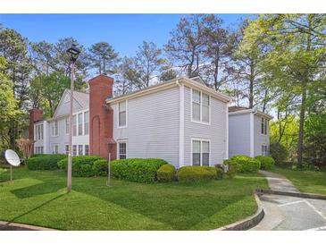Inviting condo complex featuring manicured lawns and lush landscaping at 4307 Orchard Park Ct # A, Stone Mountain, GA 30083