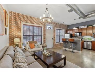 Inviting living room features exposed brick, an open layout, and industrial chic elements at 791 Wylie Se St # 1111, Atlanta, GA 30316