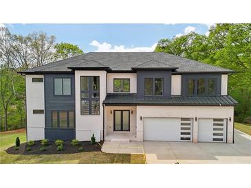New construction two-story home with a brick exterior, a two-car garage, and dark trim at 155 Westbrook St, Buford, GA 30518