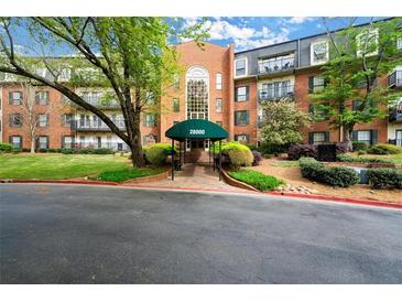 Elegant brick building with a welcoming green awning, well-maintained landscaping, and classic architectural design at 28315 Plantation Ne Dr, Atlanta, GA 30324