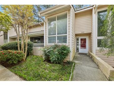 Inviting home exterior with well-maintained landscaping and a charming entrance. Number 2005 displayed on front at 2005 Variations Ne Dr, Atlanta, GA 30329