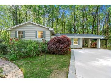 Charming single-story home with a manicured lawn and covered parking at 3300 Old Mill Ct, Decatur, GA 30033