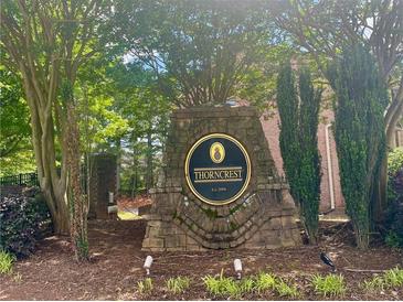 Stone sign for Thorncrest community, surrounded by greenery and trees, establishing a welcoming atmosphere at 6158 Thorncrest Dr, Tucker, GA 30084