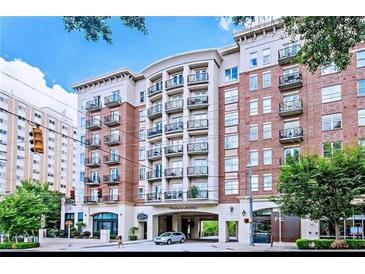 Luxury condo building featuring red brick facade, multiple balconies, and covered entrance in urban setting at 2277 Peachtree Ne Rd # 507, Atlanta, GA 30309