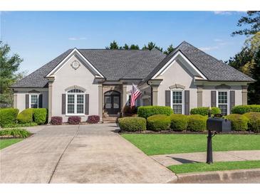 Charming home with a well manicured lawn, mature bushes, neutral colors, and a symmetrical roof line at 169 Twickenham Trce, Suwanee, GA 30024