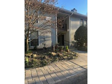 Traditional two-story townhome featuring a private balcony and stone walkway at 506 Park Ridge Cir, Marietta, GA 30068