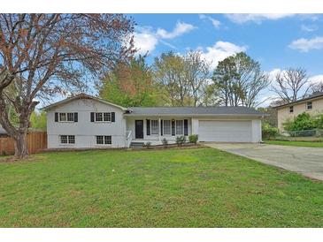 Charming ranch-style home with a well-manicured front yard and attached two-car garage at 1531 Piedmont Ne Rd, Marietta, GA 30066