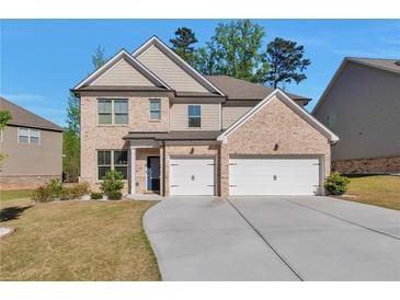 Charming two-story brick home featuring a spacious driveway and a two-car garage at 2021 Adam Acres Dr, Lawrenceville, GA 30043
