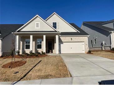 Charming, light brick home with manicured lawn and covered porch with columns at 250 Mooney Rd, Woodstock, GA 30188