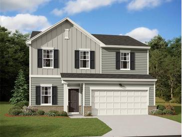 Charming two-story home with gray siding, black shutters, and an attached two-car garage at 7771 Sudbury Cir, Covington, GA 30014