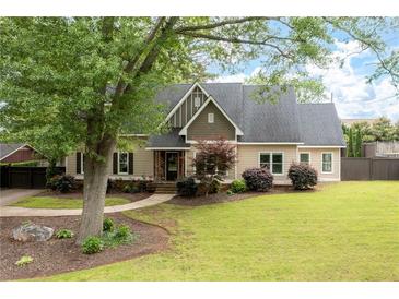 Charming home boasts a well-manicured lawn, lush landscaping, and a classic architectural style at 2356 Pinkney Dr, Marietta, GA 30062