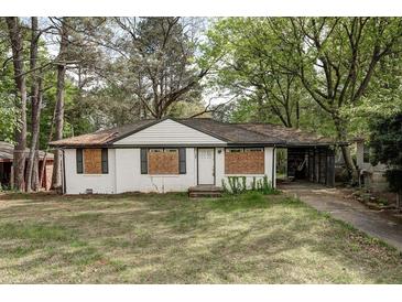 Quaint, single story home with white brick, dark trim and carport at 1809 San Gabriel Ave, Decatur, GA 30032
