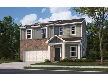 Charming two-story home features a brick and vinyl facade, attached garage, and well-maintained lawn at 7744 Sudbury Cir, Covington, GA 30014