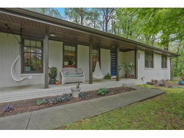 Inviting front porch with swing chairs and seating, creating a relaxing outdoor space at 3658 Brock Rd, Duluth, GA 30096