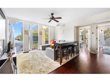 Bright living room boasts hardwood floors, neutral tones, and large windows at 287 14Th Nw St # 8, Atlanta, GA 30318