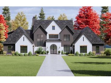 Stunning exterior with a symmetrical facade, manicured lawn and beautiful landscaping at 1280 Tynecastle Way, Sandy Springs, GA 30350