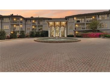 Luxury building featuring a beautiful fountain, landscaped grounds, and a circular brick driveway at 3101 Howell Mill Nw Rd # 301, Atlanta, GA 30327