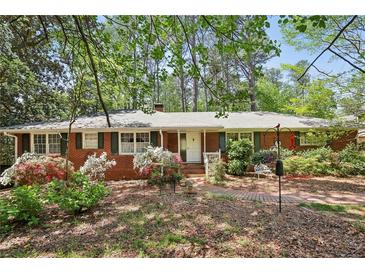 Charming brick home with beautiful landscaping and mature trees in a desirable neighborhood at 671 Valley Green Ne Dr, Atlanta, GA 30342