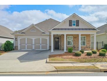 Charming single-Gathering home featuring a two-car garage, covered porch with stately columns and manicured landscaping at 807 Bridget Sw Walk, Powder Springs, GA 30127