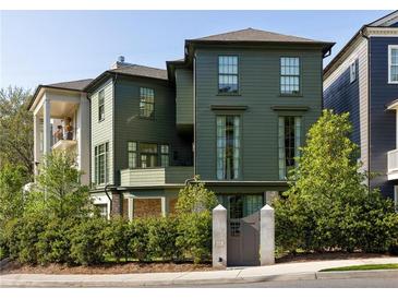 Beautiful two-story home featuring an elegant wooden gate, complemented by lush landscaping for enhanced curb appeal at 77 Delmont Ne Dr, Atlanta, GA 30305