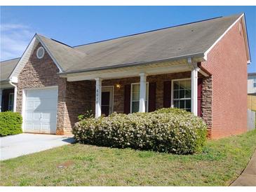 Charming single-story home featuring a stone facade, red shutters, and a well-maintained front yard at 6016 Creekerton Blvd, Mcdonough, GA 30252