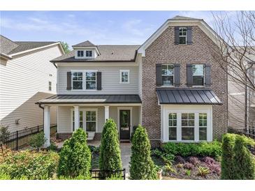 Charming two-story home featuring a combination of brick and siding, complemented by professionally landscaped yard at 2235 Chestnut Pass, Decatur, GA 30033