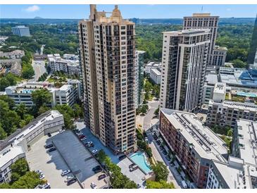 Stunning aerial view of high-rise condo with pool and parking area at 3481 Lakeside Ne Dr # 907, Atlanta, GA 30326