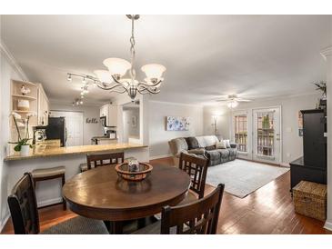 Cozy dining area with a wooden table, chairs, and view into the living room and kitchen at 408 Brighton Pt, Atlanta, GA 30328