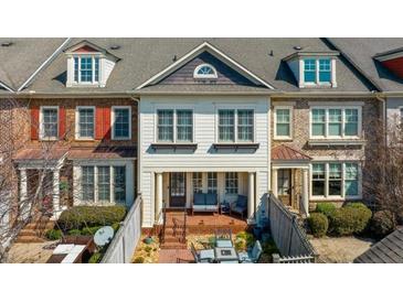 Charming townhome featuring a brick patio, two stories, and a welcoming covered porch at 6088 Holly Park Se Ln, Mableton, GA 30126