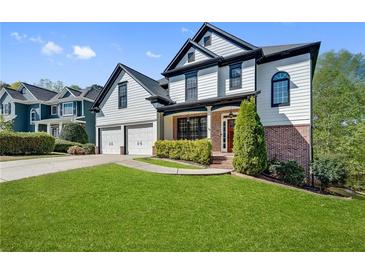 Beautiful two-story home featuring a well-manicured lawn and a two-car garage at 3085 Woodbridge Ln, Canton, GA 30114