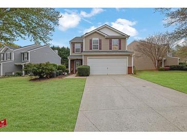 Charming two-story home with a well-maintained lawn, two-car garage, and inviting curb appeal at 2480 Sheldon Pl, Cumming, GA 30040