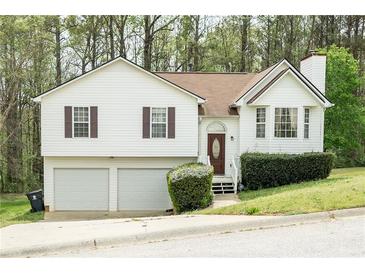 Charming two-story home with a two-car garage and well-maintained landscaping at 169 Concorde Dr, Villa Rica, GA 30180