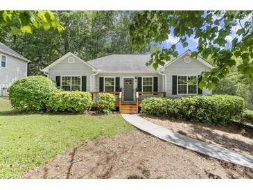 Charming single-story home with a well-manicured lawn, gray siding, black shutters, and a welcoming front porch at 3765 Michaels Way, Cumming, GA 30040