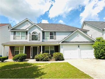 Charming two-story home with manicured lawn and attached two car garage at 2896 Spence Ct, Dacula, GA 30019