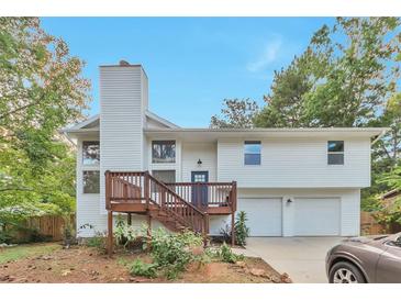 Charming exterior view of a two-story home with a wood deck and attached two-car garage at 8977 Teal Ln, Jonesboro, GA 30236