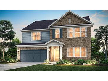 Charming two-story home with brick and siding and a cozy front porch and landscaped yard at 1636 Tide Mill Rd, Cumming, GA 30040