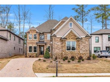 Beautiful two-story brick home showcasing a manicured lawn and charming curb appeal at 909 Sunny Meadows Lane, Marietta, GA 30062