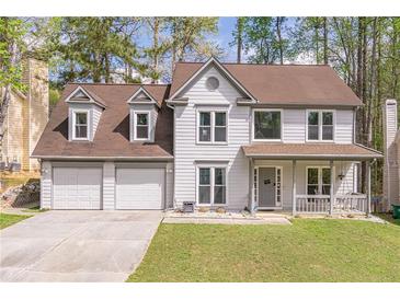 Charming two-story home with a three car garage, covered porch, and landscaped front yard at 539 Riverbirch Trce, Stone Mountain, GA 30087