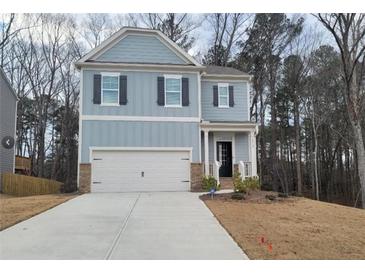 Charming two-story home with a two car garage, light blue siding and black shutters at 6615 Bluffview Dr, Douglasville, GA 30134