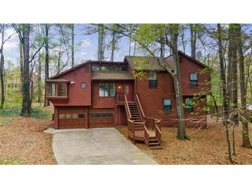 Charming two-story home with a unique architectural style and a wooded surrounding at 1150 Autumn Ridge Dr, Marietta, GA 30066
