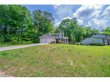 Charming two-story home with attached two-car garage and landscaped yard at 1171 Bailing Dr, Lawrenceville, GA 30043