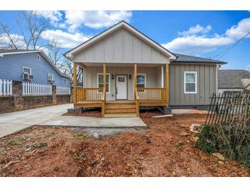 Charming home featuring a welcoming front porch and newly installed concrete driveway at 515 Federal Se Ter, Atlanta, GA 30315