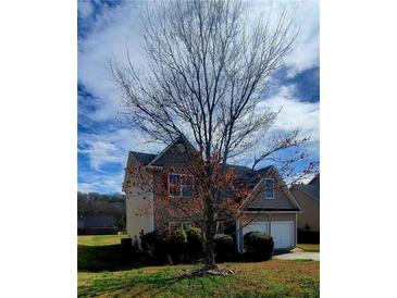 Charming two-story home featuring a two-car garage and well-maintained landscaping at 237 Summergate Ln, Villa Rica, GA 30180